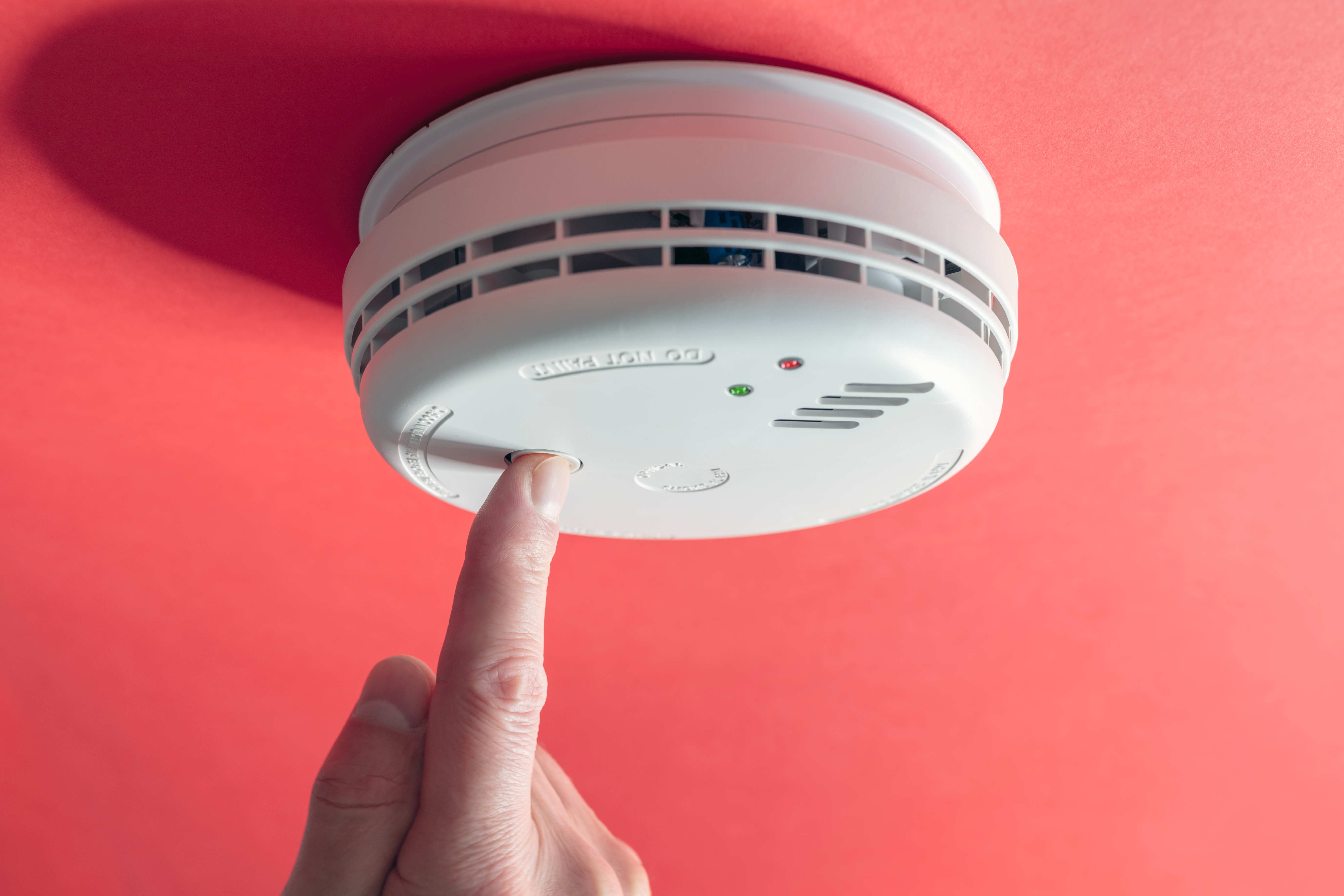 A tenant switching on the smoke detector