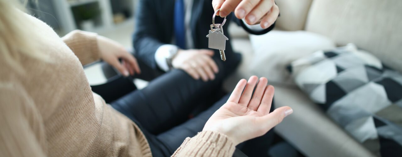 An image of a disabled tenant being handed a key